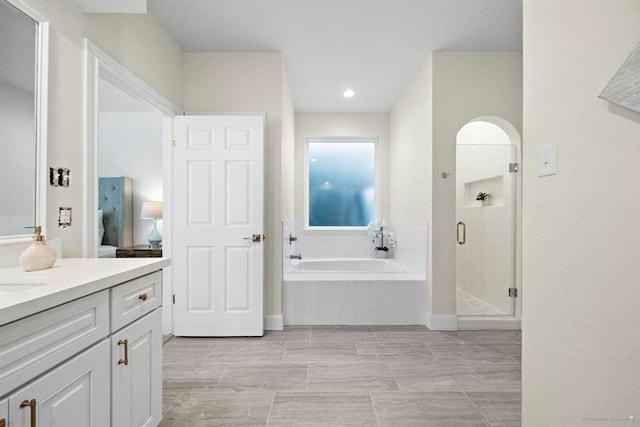 8002 Oxfordshire Dr, Spring, TX 77379 - full bath with vanity, a garden tub, a shower stall, and recessed lighting
