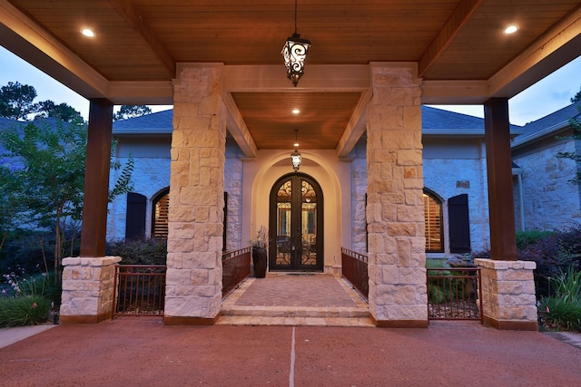 9502 Clubhouse Cir, Magnolia, TX 77354 - view of exterior entry with french doors, stone siding, and a shingled roof