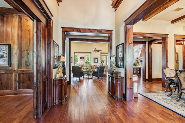 9502 Clubhouse Cir, Magnolia, TX 77354 - foyer entrance featuring beam ceiling, dark wood-type flooring, a ceiling fan, and a towering ceiling