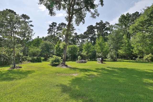 9502 Clubhouse Cir, Magnolia, TX 77354 - view of grassy yard featuring an outdoor fire pit