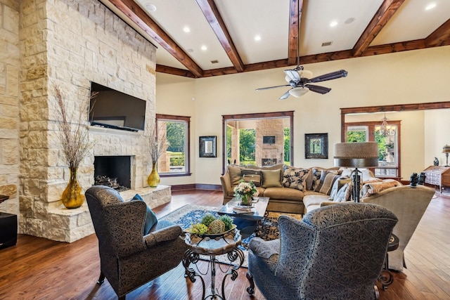 9502 Clubhouse Cir, Magnolia, TX 77354 - living area featuring beam ceiling, wood-type flooring, a ceiling fan, a stone fireplace, and recessed lighting