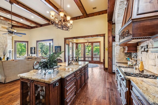 9502 Clubhouse Cir, Magnolia, TX 77354 - kitchen with a sink, stainless steel gas stovetop, a chandelier, dark wood-style floors, and beamed ceiling