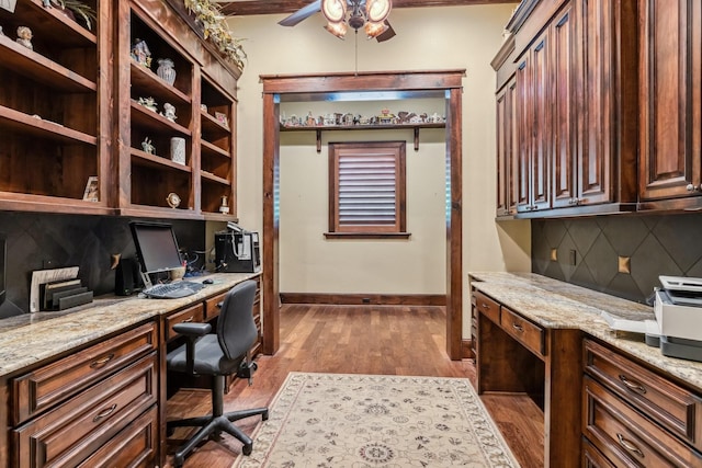 9502 Clubhouse Cir, Magnolia, TX 77354 - office space with built in desk, a ceiling fan, dark wood-style flooring, and baseboards