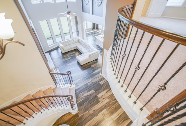 27326 Pendleton Trace Dr, Spring, TX 77386 - stairs featuring plenty of natural light, wood finished floors, ceiling fan, and a towering ceiling