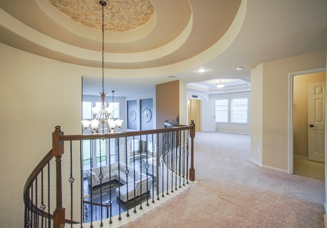 27326 Pendleton Trace Dr, Spring, TX 77386 - corridor with an upstairs landing, a chandelier, a tray ceiling, carpet flooring, and baseboards
