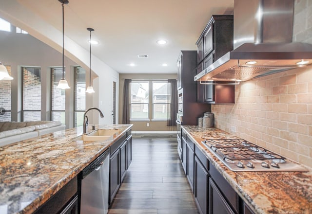27326 Pendleton Trace Dr, Spring, TX 77386 - kitchen featuring wall chimney exhaust hood, appliances with stainless steel finishes, dark wood-style flooring, a sink, and light stone counters