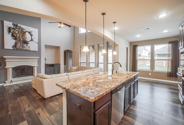 27326 Pendleton Trace Dr, Spring, TX 77386 - kitchen featuring a sink, dishwasher, dark wood-type flooring, ceiling fan, and light stone counters
