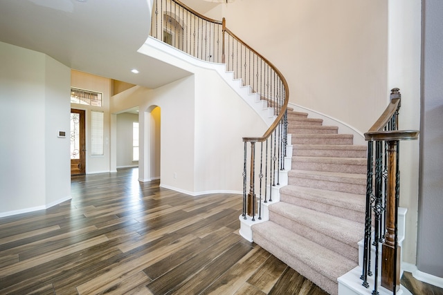 27326 Pendleton Trace Dr, Spring, TX 77386 - entrance foyer with arched walkways, wood finished floors, stairway, baseboards, and a high ceiling
