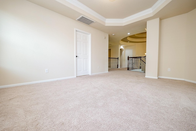 27326 Pendleton Trace Dr, Spring, TX 77386 - unfurnished living room featuring a tray ceiling, ornamental molding, carpet flooring, arched walkways, and baseboards