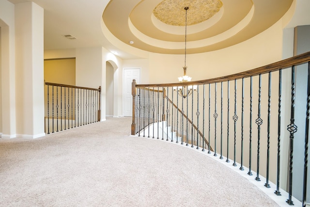 27326 Pendleton Trace Dr, Spring, TX 77386 - hall with a chandelier, carpet, baseboards, arched walkways, and a raised ceiling