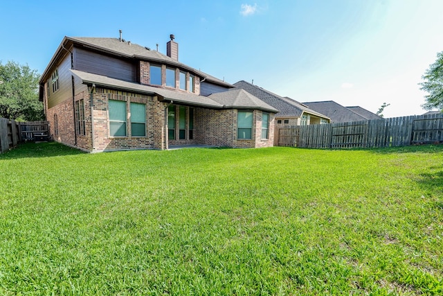 27326 Pendleton Trace Dr, Spring, TX 77386 - rear view of house with brick siding, a chimney, and central air condition unit