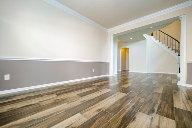 27326 Pendleton Trace Dr, Spring, TX 77386 - empty room with arched walkways, ornamental molding, wood finished floors, baseboards, and stairway