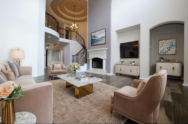 27326 Pendleton Trace Dr, Spring, TX 77386 - living area featuring a high ceiling, a chandelier, wood finished floors, baseboards, and stairs