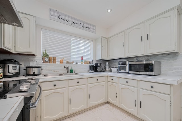 25514 Wingfield Ln, Spring, TX 77373 - kitchen with a sink, appliances with stainless steel finishes, tasteful backsplash, and recessed lighting