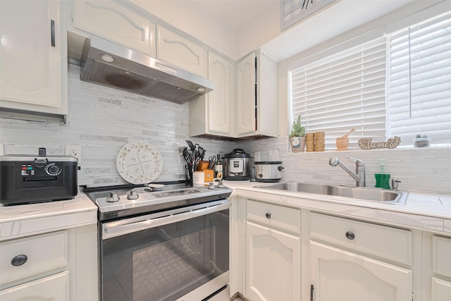 25514 Wingfield Ln, Spring, TX 77373 - kitchen featuring stainless steel electric range, ventilation hood, a sink, and backsplash