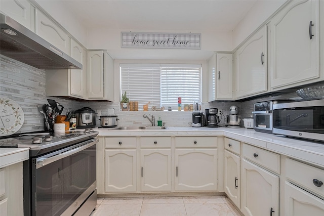25514 Wingfield Ln, Spring, TX 77373 - kitchen with wall chimney exhaust hood, a sink, appliances with stainless steel finishes, and backsplash