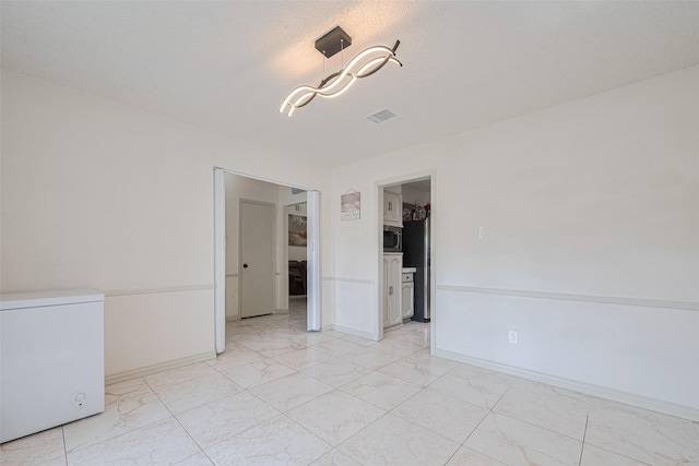 25514 Wingfield Ln, Spring, TX 77373 - spare room featuring light marble finish floors and baseboards