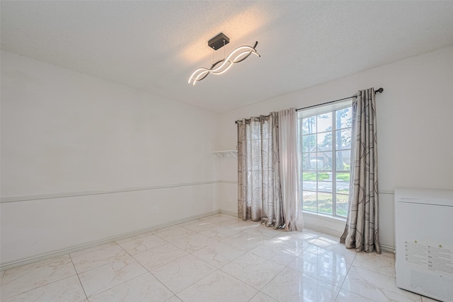 25514 Wingfield Ln, Spring, TX 77373 - unfurnished room with light marble finish floors and a textured ceiling