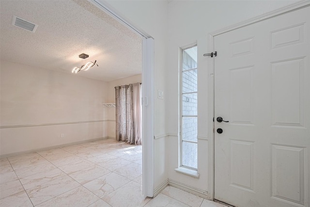 25514 Wingfield Ln, Spring, TX 77373 - entryway with a textured ceiling, baseboards, and light marble finish floors