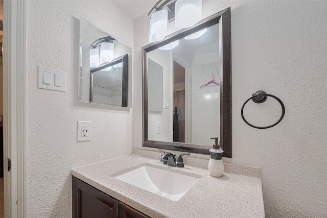 25514 Wingfield Ln, Spring, TX 77373 - bathroom featuring a textured wall and vanity