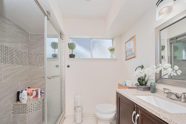 25514 Wingfield Ln, Spring, TX 77373 - bathroom with a shower stall, vanity, toilet, and tile patterned flooring