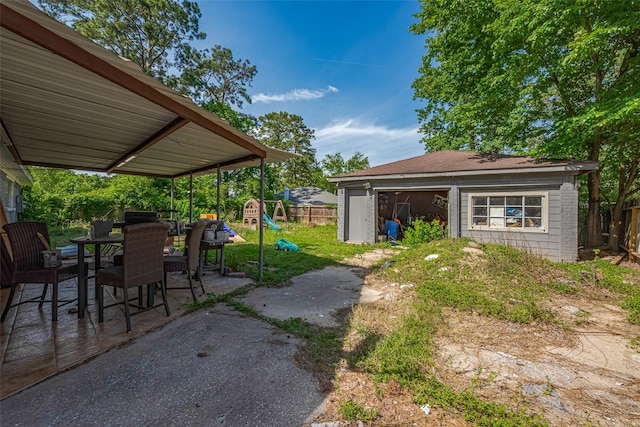 25514 Wingfield Ln, Spring, TX 77373 - view of yard with a playground, a patio area, outdoor dining area, a garage, and an outbuilding