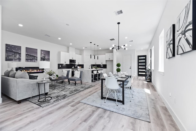 7212 England St, Houston, TX 77021 - dining room with light wood-style floors, a chandelier, recessed lighting, and baseboards