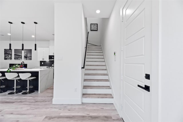 7212 England St, Houston, TX 77021 - stairs with wood finished floors, baseboards, and recessed lighting