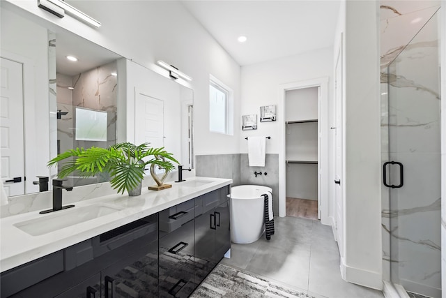 7212 England St, Houston, TX 77021 - bathroom with a marble finish shower, a freestanding bath, double vanity, a wainscoted wall, and a spacious closet
