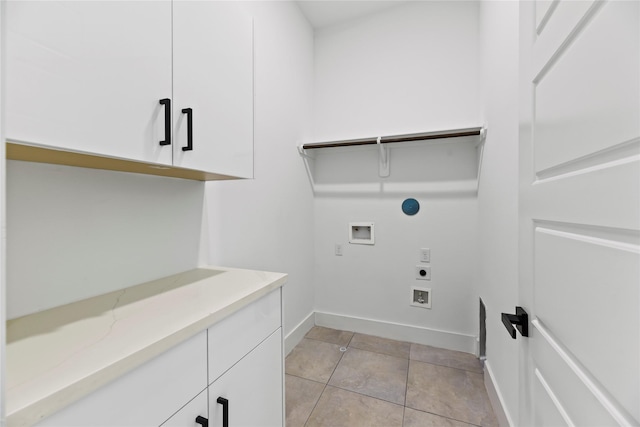 7212 England St, Houston, TX 77021 - laundry area featuring hookup for an electric dryer, washer hookup, cabinet space, baseboards, and light tile patterned floors
