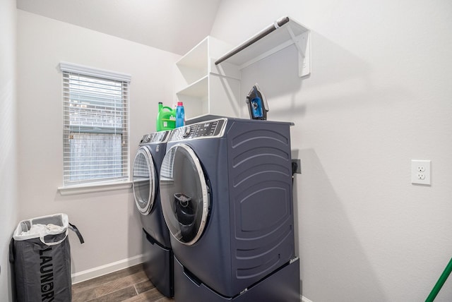 9311 Crescent Mill Dr, Missouri City, TX 77459 - washroom featuring independent washer and dryer, baseboards, and dark wood finished floors