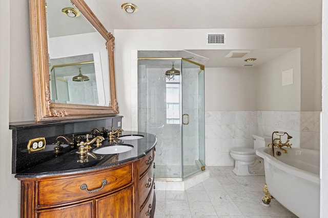 1700 Main St Unit 7B, Houston, TX 77002 - bathroom with a shower stall, toilet, a soaking tub, double vanity, and tile walls