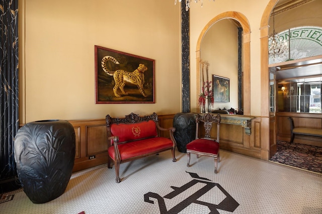 1700 Main St Unit 7B, Houston, TX 77002 - living area featuring wainscoting, carpet, and a decorative wall