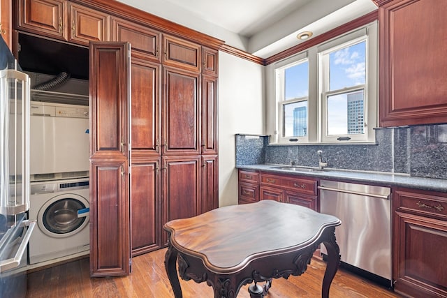 1700 Main St Unit 7B, Houston, TX 77002 - kitchen featuring dishwasher, washer / dryer, a sink, and dark brown cabinets