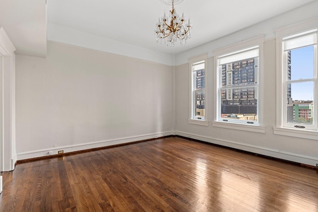 1700 Main St Unit 7B, Houston, TX 77002 - empty room with a chandelier, plenty of natural light, wood finished floors, and baseboards