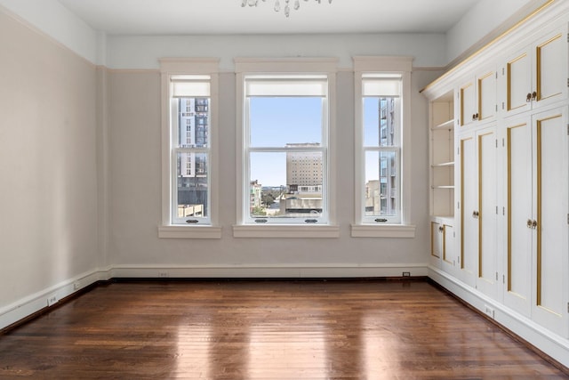 1700 Main St Unit 7B, Houston, TX 77002 - empty room featuring dark wood-style flooring and baseboards