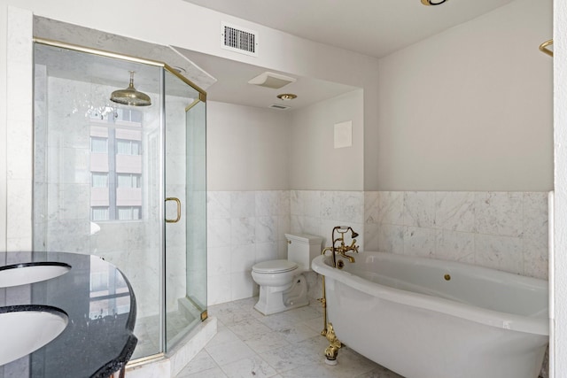 1700 Main St Unit 7B, Houston, TX 77002 - bathroom featuring toilet, a bath, a stall shower, tile walls, and wainscoting