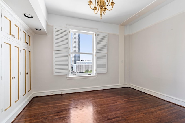 1700 Main St Unit 7B, Houston, TX 77002 - empty room featuring dark wood-style flooring, a chandelier, and baseboards