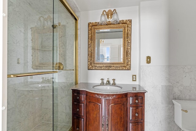 1700 Main St Unit 7B, Houston, TX 77002 - full bathroom with a shower stall, toilet, vanity, and tile walls