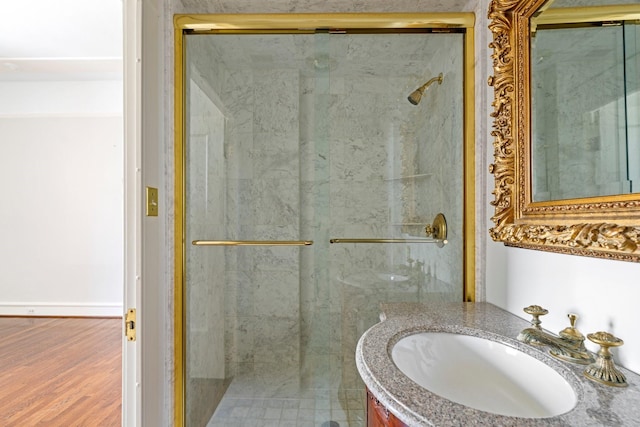 1700 Main St Unit 7B, Houston, TX 77002 - bathroom featuring a stall shower, vanity, and wood finished floors