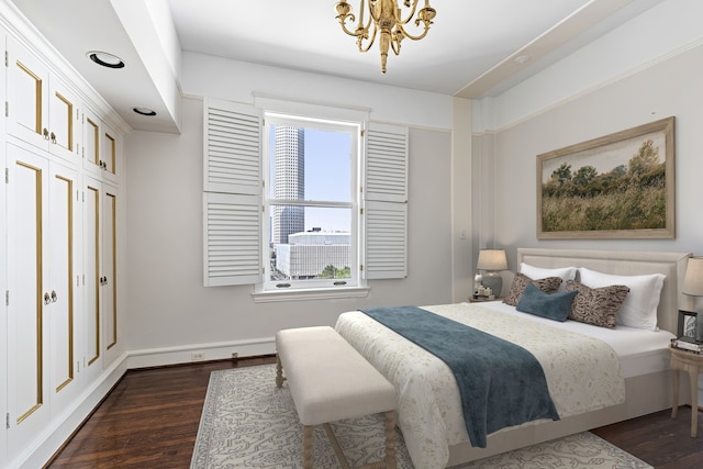 1700 Main St Unit 7B, Houston, TX 77002 - bedroom with dark wood finished floors, a chandelier, and baseboards