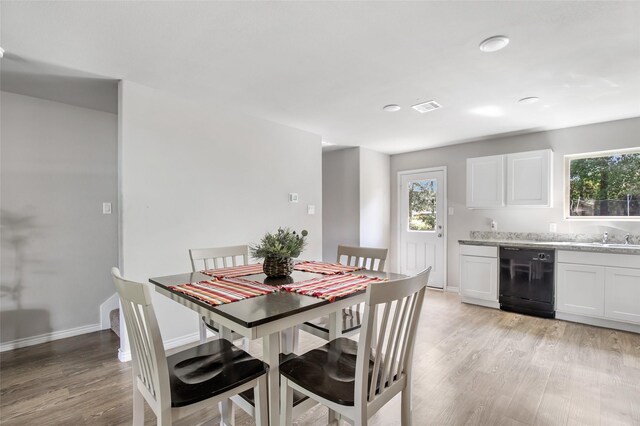 11260 Hodge Rd, Beaumont, TX 77713 - dining space featuring light wood-style floors, plenty of natural light, and baseboards