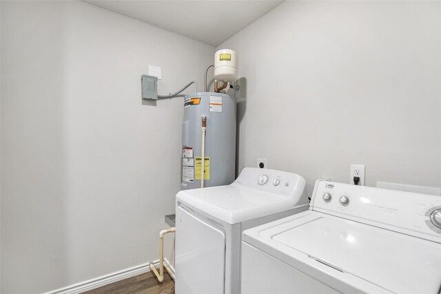 11260 Hodge Rd, Beaumont, TX 77713 - laundry room featuring washer and dryer, water heater, wood finished floors, and baseboards