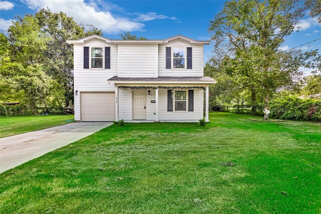 11260 Hodge Rd, Beaumont, TX 77713 - traditional-style house with a front yard, driveway, a garage, and covered porch