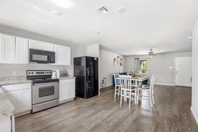 11260 Hodge Rd, Beaumont, TX 77713 - kitchen featuring black appliances, light wood-style floors, white cabinets, and baseboards