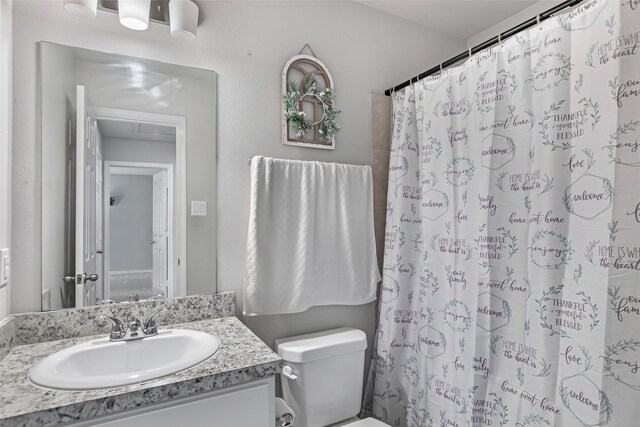 11260 Hodge Rd, Beaumont, TX 77713 - bathroom with vanity, toilet, and a shower with curtain