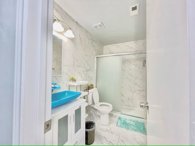 16959 Great Glen Dr, Houston, TX 77084 - full bathroom featuring marble finish flooring, a shower stall, toilet, and vanity