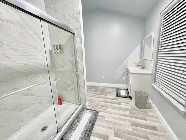 16959 Great Glen Dr, Houston, TX 77084 - full bathroom featuring a shower stall, vanity, baseboards, and wood finished floors