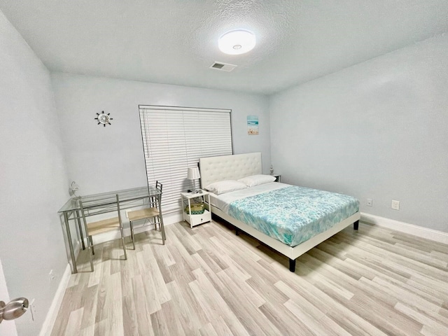 16959 Great Glen Dr, Houston, TX 77084 - bedroom featuring light wood finished floors, baseboards, and a textured ceiling