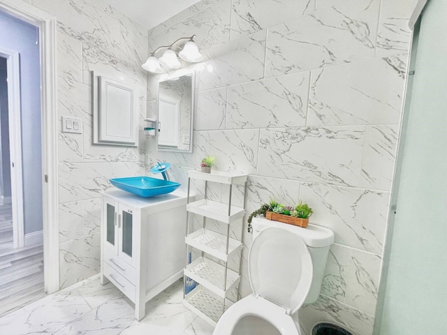 16959 Great Glen Dr, Houston, TX 77084 - bathroom with tile walls, toilet, marble finish flooring, and vanity